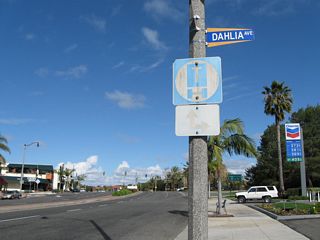 A few blocks later, northbound California 1 approaches the junction with former California 73, MacArthur Boulevard. Prior to the completion of the San Joaquin Hills Transportation Corridor (toll road), California 73 used to turn south near the University of California at Irvine and proceed along MacArthur Boulevard, ending at California 1 at this intersection. This truck route sign is the only evidence that MacArthur Boulevard used to be a state highway (as this sign is typically only used on the California state route system, not on locally maintained roads).