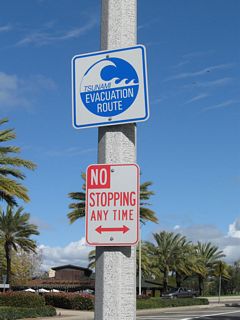 Signs like this are all over coastal Southern California to indicate evacuation routes in the event of a tsunami. These signs point the way to higher ground and safer areas.