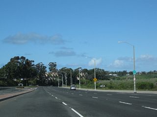 A California 1 north reassurance shield is posted after the Jamboree Road intersection, adjacent to Newport Dunes Resort along Upper Newport Bay.
