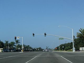 Northbound California 1 (Coast Highway) meets the signalized intersection for the entrance to Hoag Drive to Hoag Hospital.