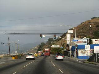 Northbound California 1 (Pacific Coast Highway) meets Entrada Drive ahead of Rustic creek and the turnoff for West Channel Road.