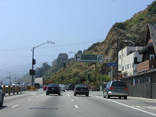 Chautauqua Boulevard follows W Channel Road from SR 1 north as a direct route to Sunset Boulevard east to notable places such as Riviera Country Club, Brentwood, and the University of California at Los Angeles (UCLA). Sunset Boulevard is a major arterial, ultimately linking Pacific Palisades with Downtown Los Angeles via UCLA and Hollywood. A portion of the road through Hollywood and Downtown at one time carried fabled designations such as U.S. 66 and U.S. 101.