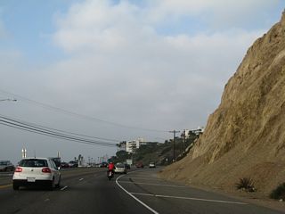 With crumbling sandstone cliffs adjacent to the Pacific Coast Highway, it becomes evident why certain areas have retaining walls.