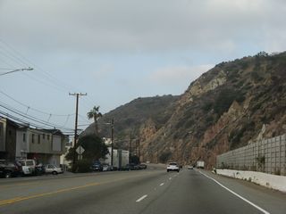 Some of the homes on the south side of SR 1 near postmile 43.20 survived the Palisades Fire. Further west, others were not so fortunate.