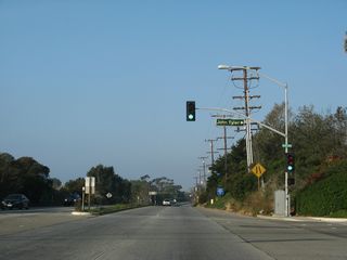 Passing Malibu Bluffs peak, California 1 (Pacific Coast Highway) advances west to John Tyler Drive north to Pepperdine University's campus.