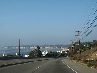 Distant Point Dume appears along the Pacific coast from California 1 (Pacific Coast Highway) west of Latigo Canyon Road.