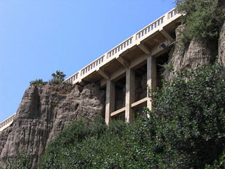 The California Incline connects California Avenue and Ocean Avenue with California 1 (Pacific Coast Highway) in Santa Monica. Bridge structures (sidehill viaducts) and roadway surfaces built into the hillside (approximately 1,400 feet in length) carry the Incline over the irregular bluffs as the street leads downhill; these were largely built in the 1930s. The California Incline itself was first conceived in 1896 as the "Sunset Trail"; the structure seen here was buit in 1930. Starting on April 20, 2015, the city of Santa Monica began construction toreplace the California Incline, with completion in 2016.