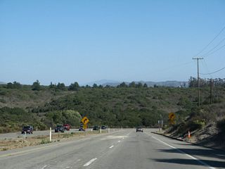 After Exit 211 (Constellation Road to Vandenberg Village), southbound California 1 descends into the Santa Ynez River valley.