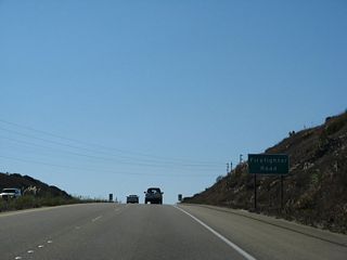 Southbound California 1 (Cabrillo Highway) approaches Firefighter Road. Turn right here to connect to the Vandenberg Space Force Base Utah Gate. Continue straight to the main gate for the base.