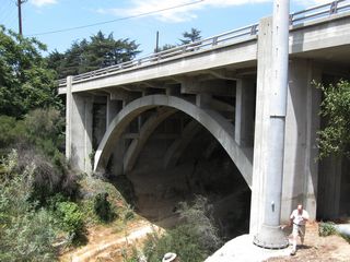 Continuing uphill and leaving La Canada-Flintridge, California 2 enters the Angeles National Forest. The state route will travel along the hillsides to gain elevation and work its way up toward the crest. Here, another concrete arch bridge carries California 2 over Slide Canyon, about three miles after the Arch Canyon bridge. The Slide Canyon Bridge was built in 1931 as the Angeles Crest Highway was under construction.