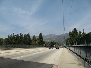 Northbound California 2 (Angeles Crest Highway) passes over Interstate 210. After crossing the freeway, Angeles Crest Highway will gain elevation as it ascends into the San Gabriel Mountains.