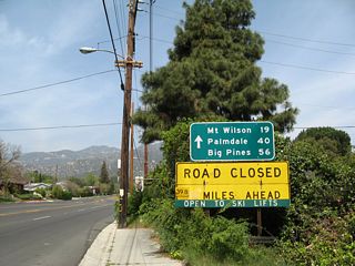From here, California 2 will leave the urban environs and become an exclusively mountain highway. Due to the winding nature of the highway through the San Gabriel Mountains, a yellow warning sign advises that certain trucks are restricted from the Angeles Crest Highway.