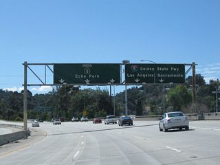 The right two lanes of California 2 (Glendale Freeway) south will connect to Interstate 5 (Exit 13A). Interstate 5 travels north to Santa Clarita, Sacramento, Redding, Eugene, Portland, and Seattle before ending at the International Border with Canada. To the south, Interstate 5 travels past downtown Los Angeles (staying closer to East Los Angeles and Boyle Heights), then continues toward Anaheim, Santa Ana, Irvine, Oceanside, and San Diego (ending at the International Border with Mexico).