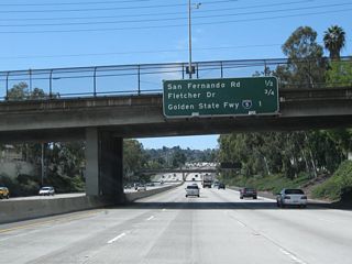 This interchange sequence sign along California 2 (Glendale Freeway) west (south) provides the distance to the next three exits: Exit 14, Historic San Fernando Road (old U.S. 6-99) (former Business Loop I-5); Exit 13B, Fletcher Drive; and Exit 13A, Interstate 5 (Golden State Freeway). U.S. 99, the Main Street of California, used to extend from Calexico north to the Oregon border near Yreka until it was decommissioned in stages beginning in 1964. In the greater Los Angeles area, U.S. 99 was replaced by Interstate 10 from Indio west to downtown Los Angeles and by Interstate 5 from downtown north to Wheeler Ridge, where it split off onto California 99. U.S. 6 was also eliminated from Los Angeles in 1964, and it now terminates in Bishop where it meets U.S. 395 in the Eastern Sierra. Remnants of the old road include San Fernando Road, which used to carry both U.S. 6 and U.S. 99 from the north into Los Angeles.