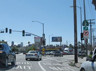 At Alvarado Street, California 2 departs from Glendale Boulevard and travels southwest toward its interchange with U.S. 101. From there, the two routes will share alignment briefly, then separate again at the Santa Monica Boulevard interchange. California 2 then follows Santa Monica Boulevard west to Santa Monica (although certain segments have been decommissioned from the state system as Caltrans continues to turn state routes that follow conventional city streets over to the city for operation and maintenance).