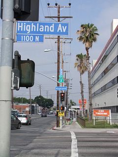 About 15 blocks west of its split from U.S. 101 (Hollywood Freeway), westbound California 2 (Santa Monica Boulevard) meets California 170 (Highland Avenue). Turn right on Highland Avenue north to merge with U.S. 101 near the Cahuenga Pass. Note the old, porcelain-enamel, white-on-blue street sign blade for Santa Monica Boulevard.