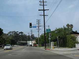 Northbound Riverside Drive meets Newell Street. An Interstate 5 trailblazer is also posted on the traffic signal pole.