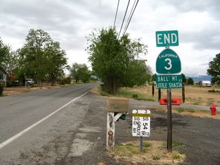 At the Montague eastern city limits, California 3 and state maintenance ends. The sign clearly shows the end of the route, even though the locally maintained pavement continues beyond this point. The auxiliary sign beneath the end California 3 assembly says, "Ball Mountain-Little Shasta Road." This is the name of the county road that continues along the alignment of California 3 from this point eastward. Note the milepost equations in both directions. California 246 ends in a fashion similar to this, as it terminates at the western city limits of Lompoc, but a county route continues on its alignment all the way to the coast. Ball Mountain-Little Shasta Road is improved for a fair distance, but it is not fully paved all the way east to U.S. 97 as it follows the Little Shasta River east past Goosenest Mountain.