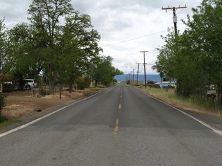 At the city limits, the pavement color changes. State maintenance ends and county maintenance begins.