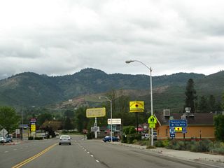Southbound Business Loop I-5 and California 3 (Montague Road) approach their intersection with Historic U.S. 99 and California 263 (Main Street). California 3 and Business Loop I-5 turn left here; California 263 ends at this point. Follow Main Street south to the tourist information center, which is located off Miner Street.