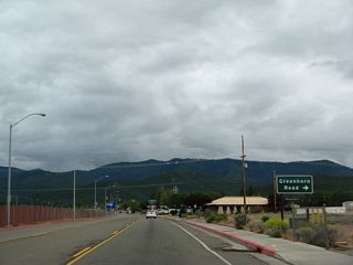 Amidst shopping areas, Business Loop I-5 and California 3 (Main Street) approach Greenhorn Road.