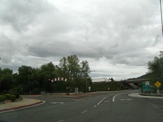 Between Interstate Exit 775 and California 3 and Business Loop I-5 (Main Street) in Yreka is the one-way couplet of Miner Street (westbound) and Center Street (eastbound). At the point where these two roads unite just west of Interstate 5 and east of California 3, we find an arch welcome sign located in the median formed between the two roadways. The arch was dedicated in 1976 and is illuminated. It was previously located over the intersection of U.S. 99/Main Street and Miner Street; it resided there from around 1917 until the 1930s when U.S. 99/Main Street was widened.1 The sign went into storage until being relocated to the intersection of Miner Street and Center Street just west of Interstate 5.