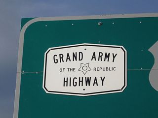 U.S. 6 is the Grand Army of the Republic Highway, which is signed with an almost-hexagonal shield such as this one affixed to the Provincetown mileage sign. (Look closely, and you'll see the shield actually has ten sides rather than six, but from a distance it looks like a six-sided sign.) U.S. 6 is also known as the Midland Trail across eastern California and Nevada.
