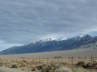 The snow-capped White Mountain line the west side of the Chalfant Valley and are readily visible from U.S. 6 on clear days. Continuing straight ahead, a mileage sign along U.S. 6 north provides the distance to Benton (16 miles), Tonopah (94 miles), and Ely (261 miles). The metric distances were kept on this newer, reflective mileage sign.
