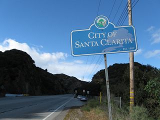 Northbound Sierra Highway (old U.S. 6) enters the city of Santa Clarita. Incorporated on December 15, 1987, Santa Clarita had a population of 151,088. The city incorporates Valencia, Newhall, Saugus, and Canyon Country. As a result of explosive development in the 1990s and 2000s, Santa Clarita saw significant population gains.