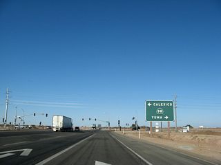Now approaching California 98, a right turn follows California 98 east to Interstate 8 at Midway Well. To Yuma, follow Interstate 8 east through the Imperial (Algodones) Sand Dunes and over the Colorado River into Arizona. Looking west, it is about eight miles east to the border city of Calexico, which is located just north of Mexicali, Baja California, Mexico.