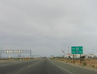 This mileage sign provides the distance to California 98 (0.75 mile) and Interstate 8 (6.25 miles). The entire route to Interstate 8 is expressway, with only two traffic signals (one for Maggio Road and the other for California 98) between here and the Interstate Highway System. California 7 was constructed with the intent of providing a direct connection from Mexico to Interstate 8 without using the local street network or rural farm-to-market highways.