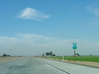 Another California 7 reassurance shield is posted after the Heber Road intersection. The verdant fields east of the expressway are part of the winter growing season in the eastern Imperial Valley.