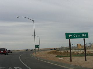 The first intersection along northbound California 7 is with Menvielle Road (signed as Carr Road). Turn north on Menvielle Road, then turn west on Carr Road. Carr Road travels west to serve local farms and ranches in this section of Imperial County. The construction of the port of entry, which was completed in the late 1990s, resulted in the realignment of Carr Road to the current configuration.