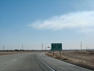 To the east, California 98 follows Cole Road to Interstate 8 Exit 143. From there, Interstate 8 crosses the Algodones Dunes to Winterhaven and Yuma. There are no services along California 98 east until Interstate 8 meets Sidewinder Road at Exit 164 (Felicity). To the west is Calexico. Motorist services are available in Calexico, and gas and food are available at the border crossing by continuing south on California 7.