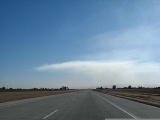California 7 is a four-lane, divided concrete expressway with intersections spaced about a mile apart. The first intersection is with McCabe Road, followed by Heber Road.