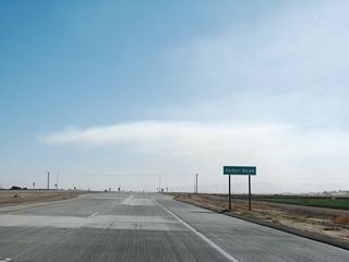Southbound California 7 meets Heber Road at this intersection. Through traffic on the expressway does not stop, and there are turn lanes for all movements.