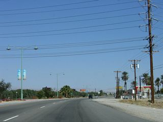 A set of Imperial Irrigation District power lines cross over Indio Boulevard beside Coachella Canal.