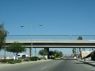 Eastbound Business Loop I-10 (Indio Boulevard) passes under Golf Center Parkway.