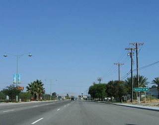 Indio Boulevard parallels the Union Pacific Railroad southeast from ahead of Madison Street. Indio Boulevard was originally built as an expressway toward Downtown Indio, but its high-speed aspects have diminished as the roadway transitioned into a four-lane arterial with adjacent business access points.