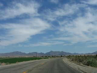 Hobson Way curves southward toward Interstate 10 across agricultural development beyond Olive Lake Boulevard.