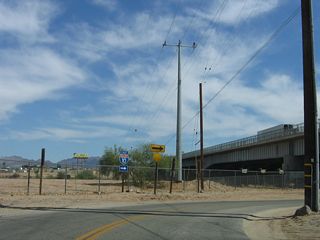 Business Loop I-10 (Riveria Drive) turns south to pass under Interstate 10 at Quechan Park. Historically, the crossing of the Colorado River between Blythe and Ehrenberg was accomplished via a ferry. In the late 1920s, the ferry was replaced by a two-lane bridge, but the bridge was removed after the modern Interstate 10 bridge opened in 1960.