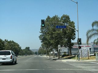 Westbound Business Loop I-10 (Holt Avenue) meets Erie Street at this traffic signal.