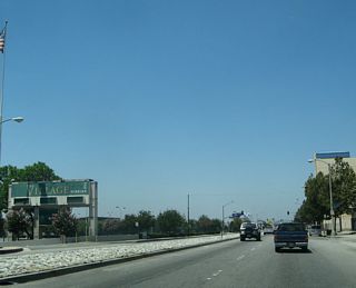 The Village at Indian Hill education conference center lines the south side of Holt Avenue along this stretch. The Village is described as "a specialized mixed-use facility designed to support K-12 teaching and learning, proessional development and parent education." This former mall was acquired by the school district in 1995 and recreated into a learning center.