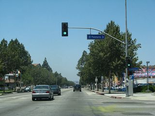 The next signalized intersection along westbound Business Loop I-10 (Holt Avenue) is with Palomares Street.
