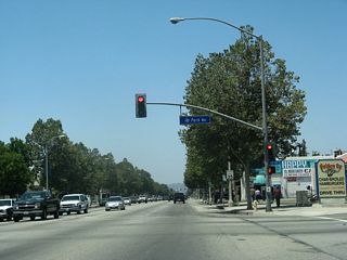 Westbound Business Loop I-10 (Holt Avenue) meets Park Avenue at this traffic signal.