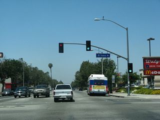 Holt Avenue advances west to Pomona's antique row, arts colony, transit center, Western University, and civic center. Towne Avenue runs south to SR 71 (Chino Valley Freeway) and north to Interstate 10 at Exit 48 and the city of Claremont.