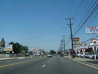 Car dealerships, auto parts stores, and strip malls line this stretch of Holt Boulevard.