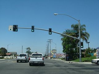 The next traffic signal along westbound Business Loop I-10 (Holt Boulevard) is with San Antonio Avenue. Ontario Village shopping plaza is located on the northeast corner of this intersection. South of Holt Boulevard, San Antonio Avenue crosses the Union Pacific Railroad ahead of residential areas to Francis Street east of Ontario High School.