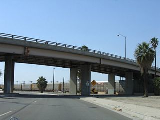 Continuing northwest from Civic Center Drive, Indio Boulevard (Historic U.S. 60-70-99) pass under the Jackson Street viaduct spanning the Union Pacific Railroad.