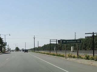 Westbound Business Loop I-10 (Indio Boulevard) meets Madison Street at the next traffic signal.